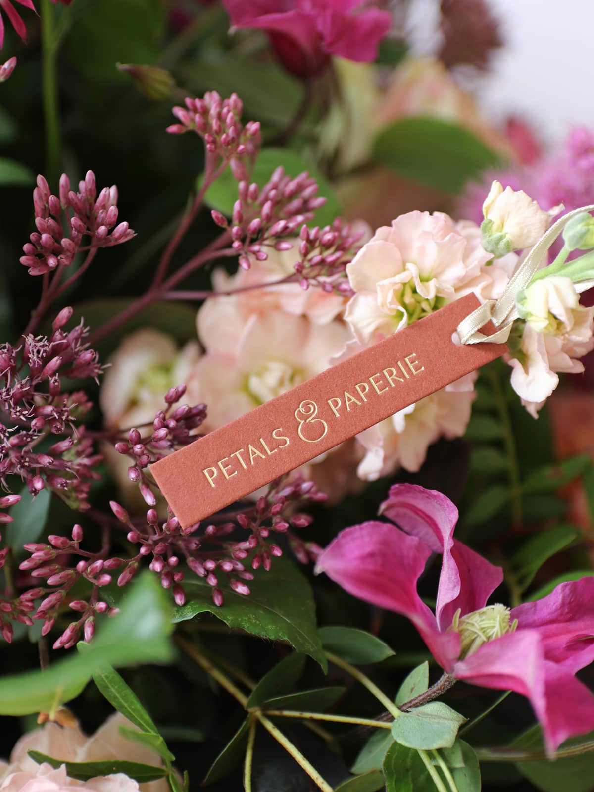 Floral arrangement with a 'Petals & Paperie' tag