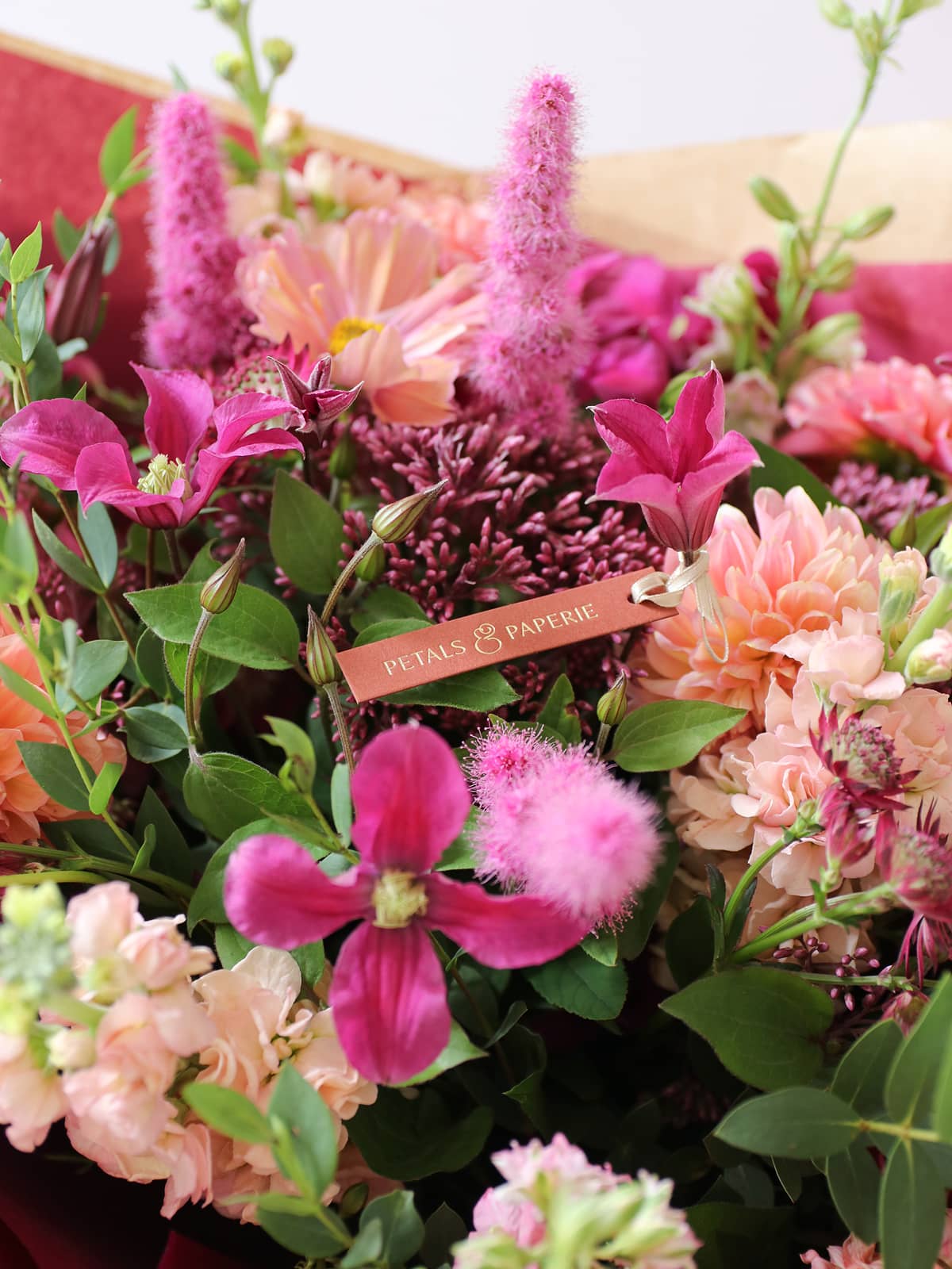 Bouquet of flowers with a 'Petals & Paperie' tag