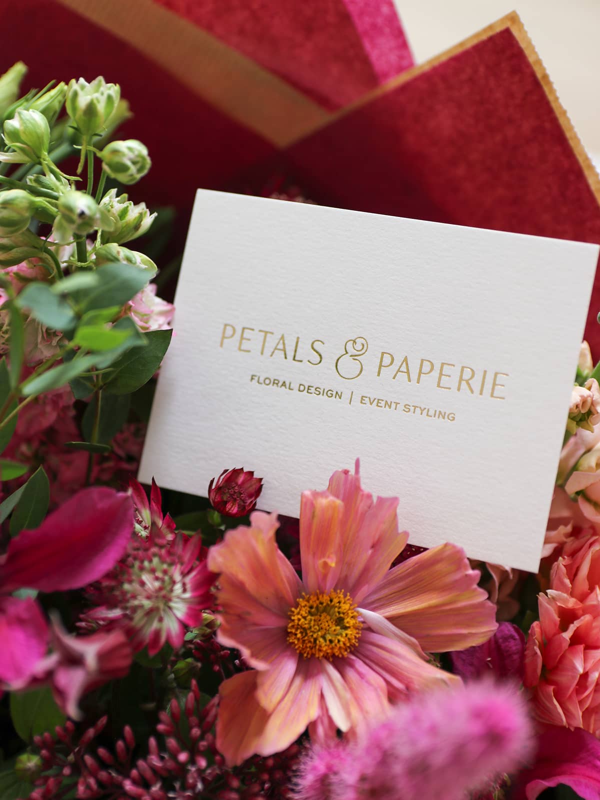Floral arrangement with a 'Petals & Paperie' message card