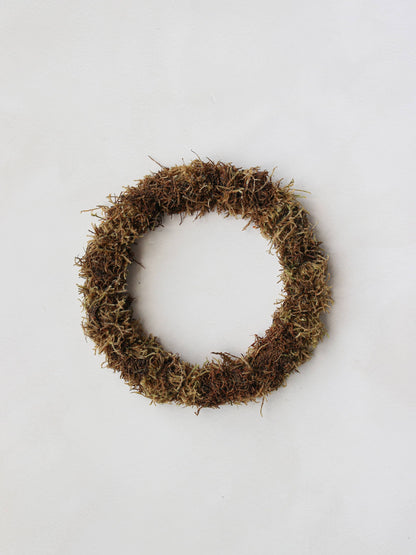 A mossed wreath base on a neutral background.