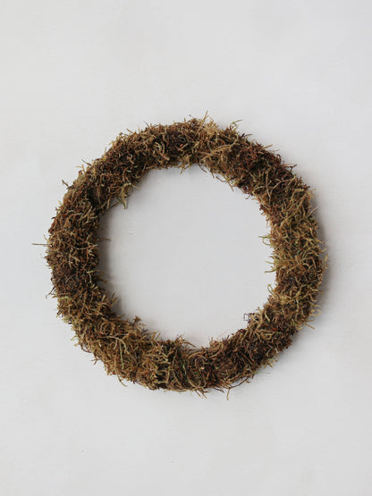 A mossed wreath base on a neutral background.