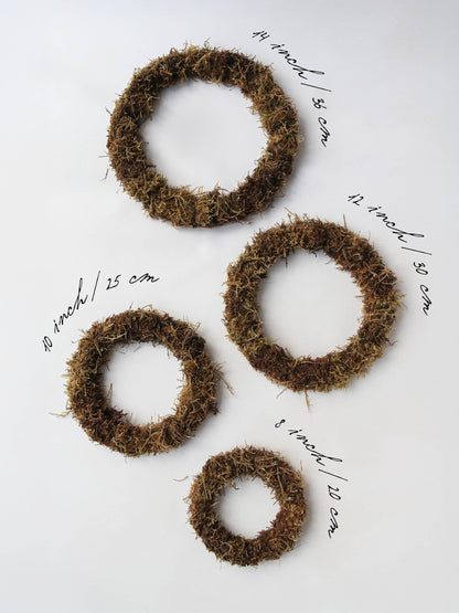 Four mossed wreath bases in varying sizes lying on a neutral background with the measurements of the wreath next to them.